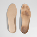 Two shoe insoles, one clean and one worn, on a light gray background